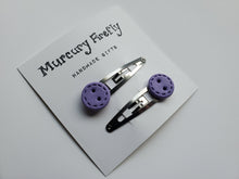 Load image into Gallery viewer, Stainless steel snap clips with a handmade decorative button on each one. Shown in the light purple color (color number 12) with the Stitch design.