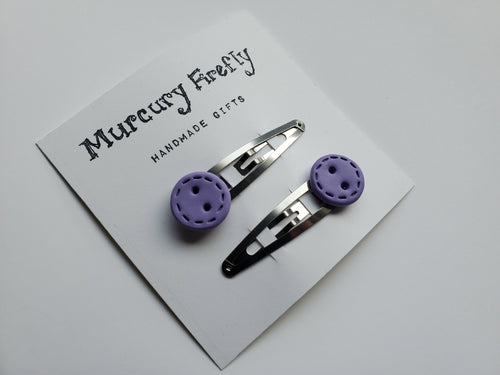 Stainless steel snap clips with a handmade decorative button on each one. Shown in the light purple color (color number 12) with the Stitch design.